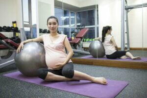 Pregnant woman resting at gym